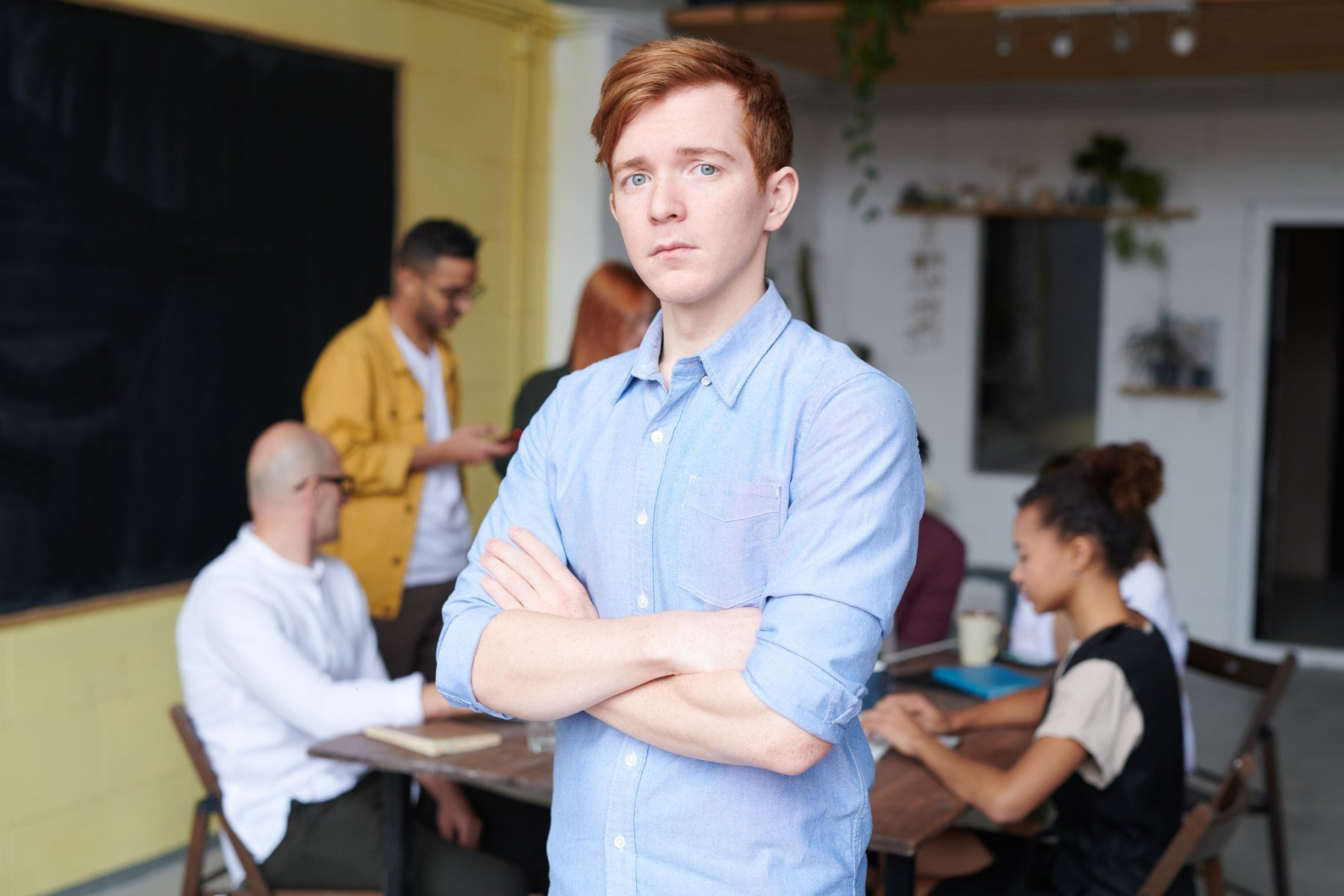 Young businessman in the office with colleagues in the background